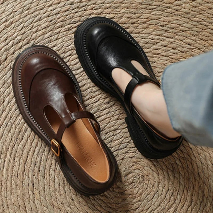 Blythe T-bar mary jane shoes in black, side profile showing adjustable buckle strap and low heel