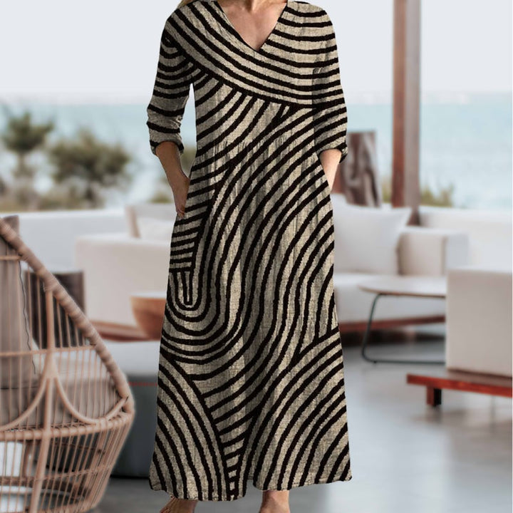 Close-up detail of the brown and black stripe pattern and V-neckline on a lightweight vintage-inspired dress