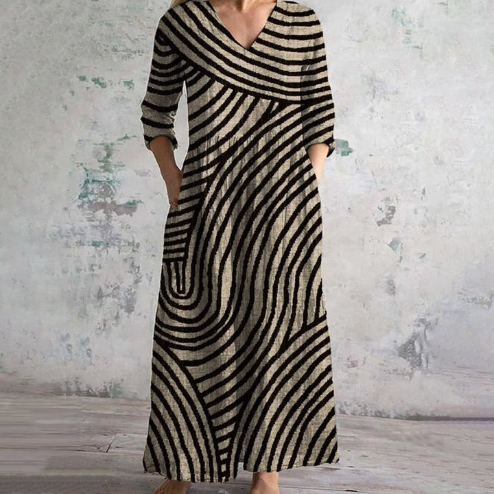 Full-length view of a vintage striped dress in brown and black showing the relaxed fit and hidden side pockets