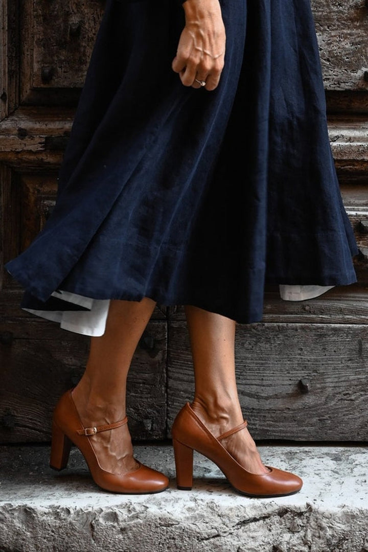 Close-up of the buckle strap detail on brown low-heel women's sandals