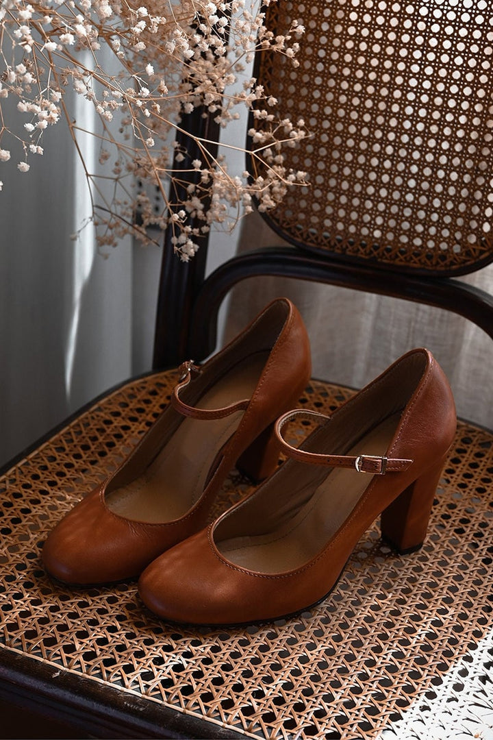 Brown low-heel women's sandals styled in a lifestyle setting