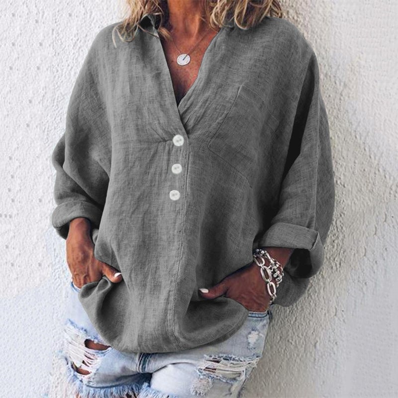Model wearing the Breeze top in black with sleeves casually rolled up at the cuff