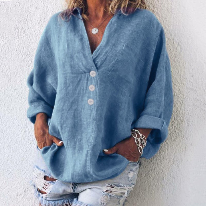 Flat lay of the Breeze v-neck oversized top in blue showing full length and button placket detail