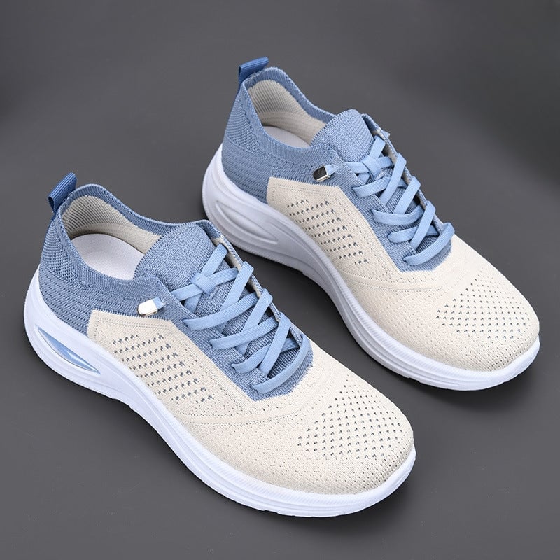 Side view of women's mesh walking sneakers showing two-tone knit upper and lace-up closure