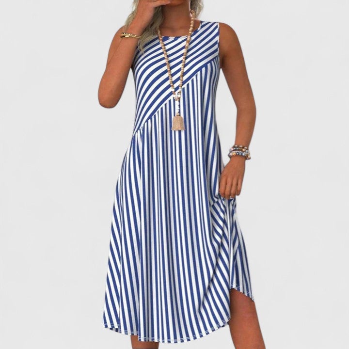 Woman wearing a blue and white striped sleeveless midi dress with a round neckline and relaxed A-line silhouette