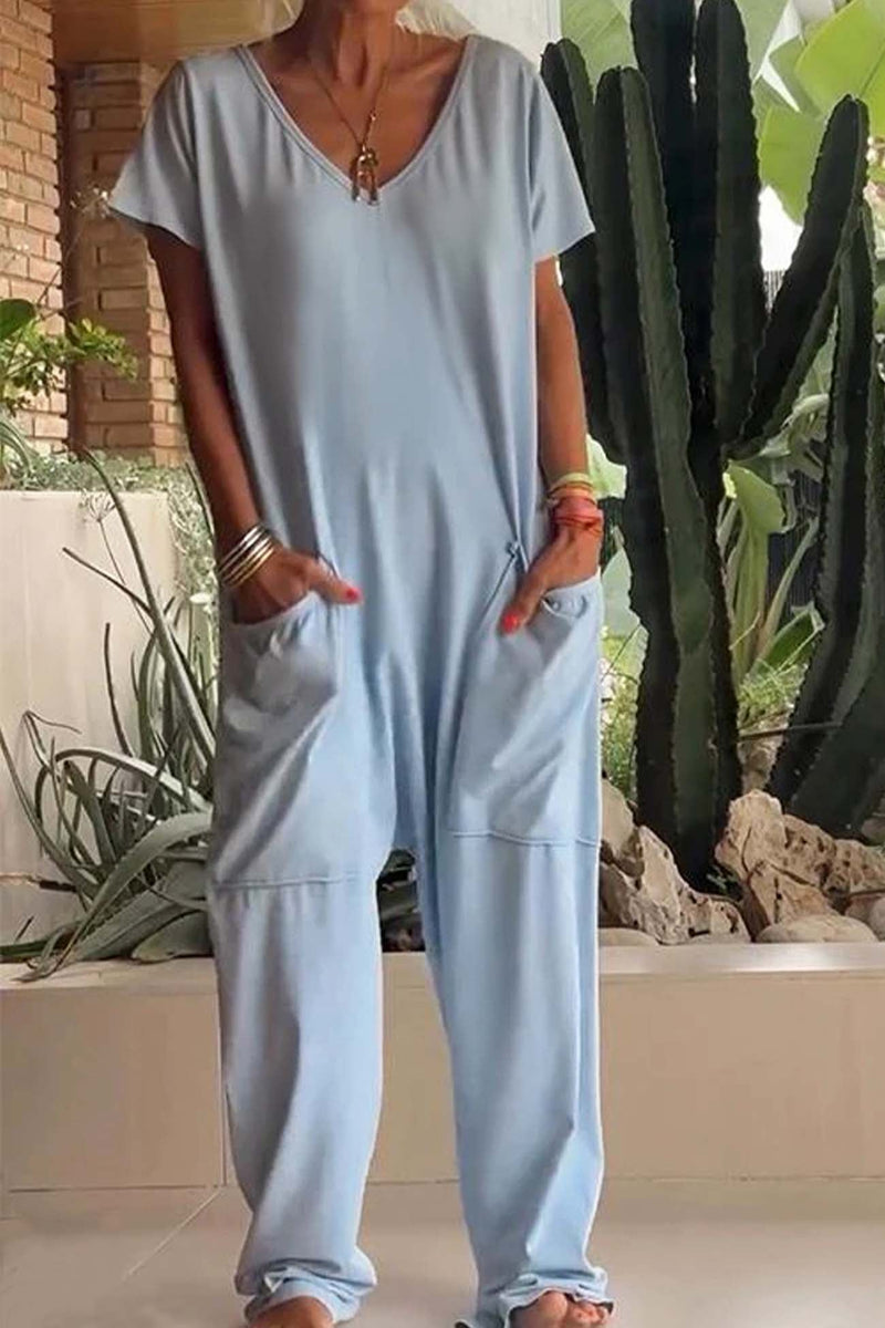 Side view of the relaxed drop-crotch jumpsuit in beige highlighting the tapered leg and patch pockets