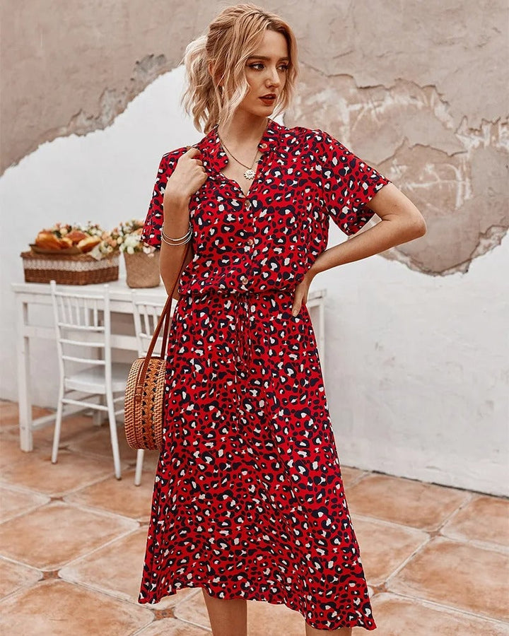 Model wearing the Brenda summer dress in orange colorway styled for a casual summer outing