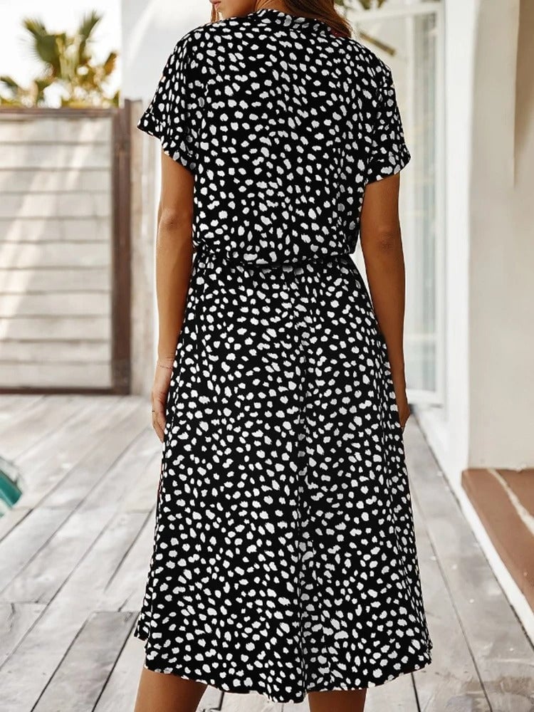 Full-length lifestyle shot of the Brenda summer dress worn outdoors in a summer setting