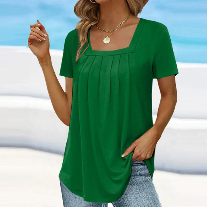 Close-up of the soft front pleats and square neckline on the Florimay elegant pleated blouse
