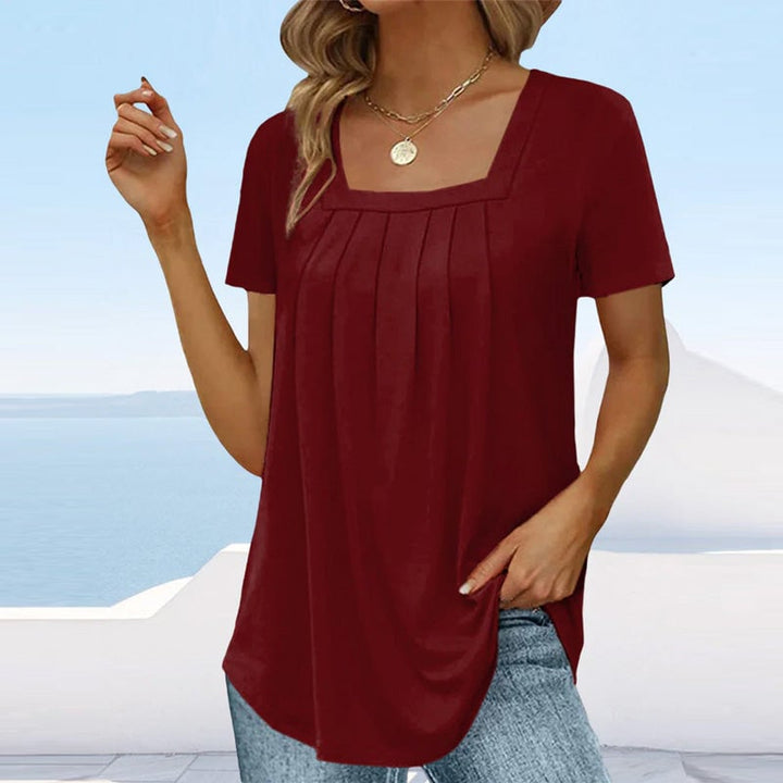 Full-length view of model wearing the Florimay pleated blouse in Burgundy Wine