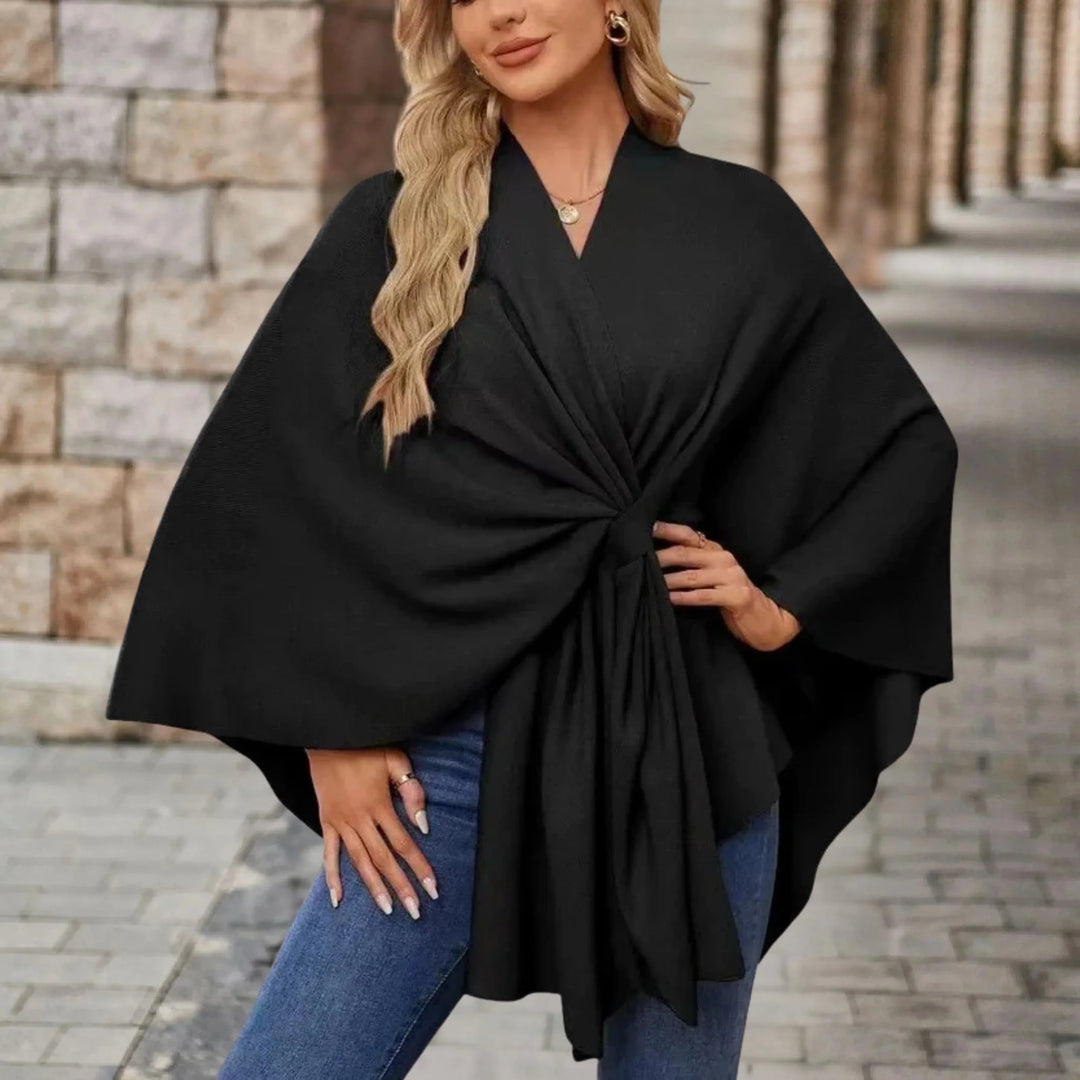 Draped poncho shown in a neutral color with graceful flowing fabric