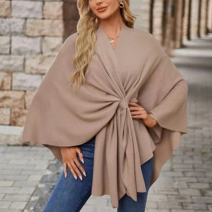 Side view of an elegant poncho highlighting its flattering silhouette