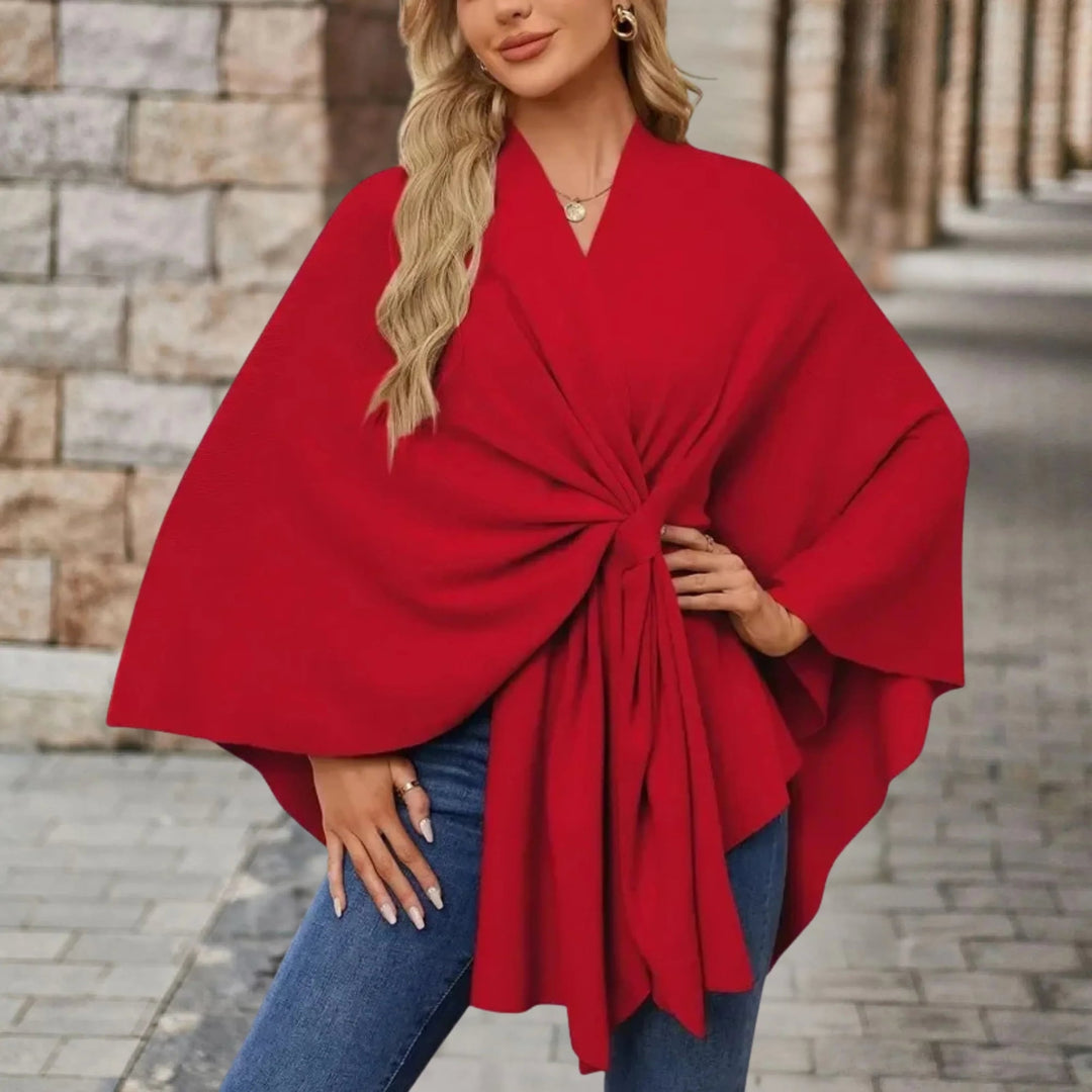 Woman in a flowing poncho with front knot detail styled for a casual outing