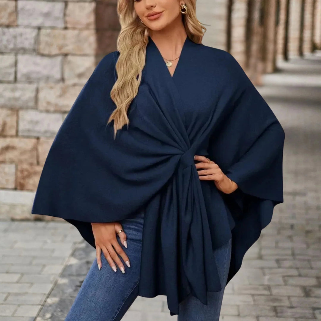 Draped poncho displayed in multiple available colors on a clean background
