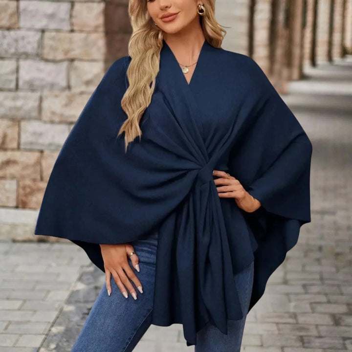 Draped poncho displayed in multiple available colors on a clean background