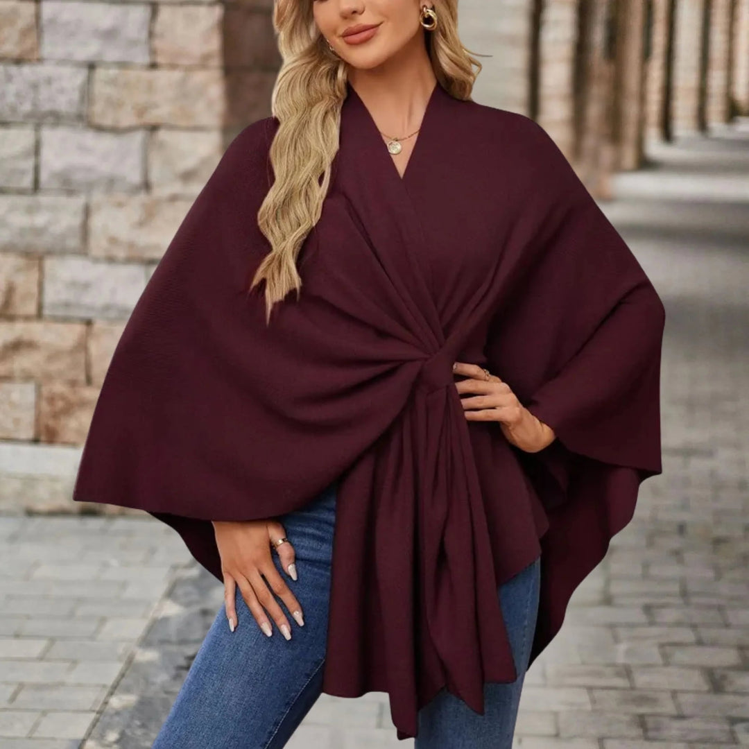 Back view of an elegant draped poncho showing the full length and drape