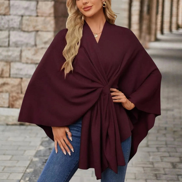 Back view of an elegant draped poncho showing the full length and drape