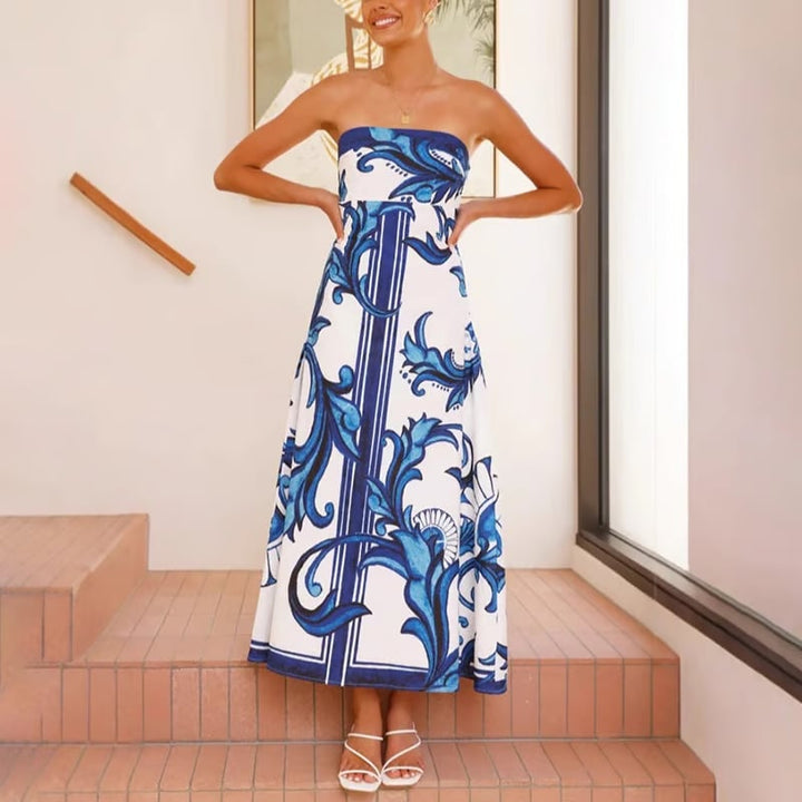 Woman in the Briar light blue printed dress styled with heeled sandals for a wedding guest look