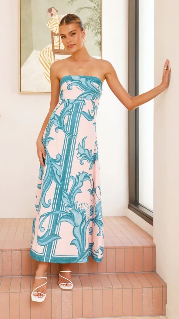 Side profile of the Briar printed dress in light blue highlighting the flattering elongated silhouette