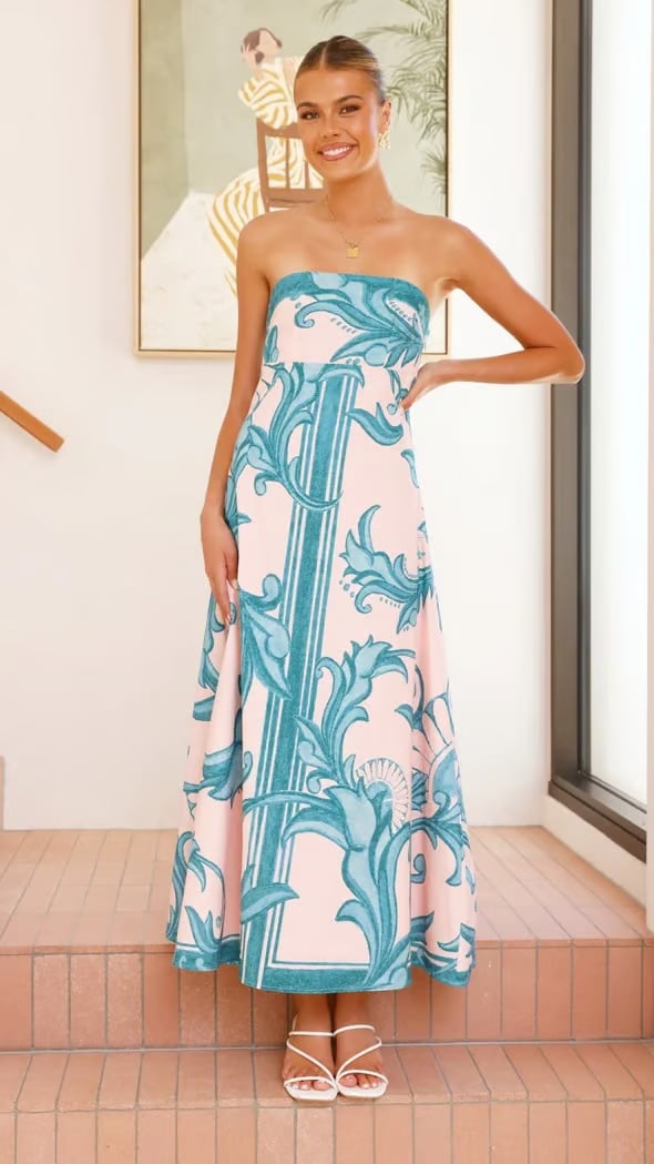 Full-length shot of the Briar wedding guest printed dress in light blue on a standing model
