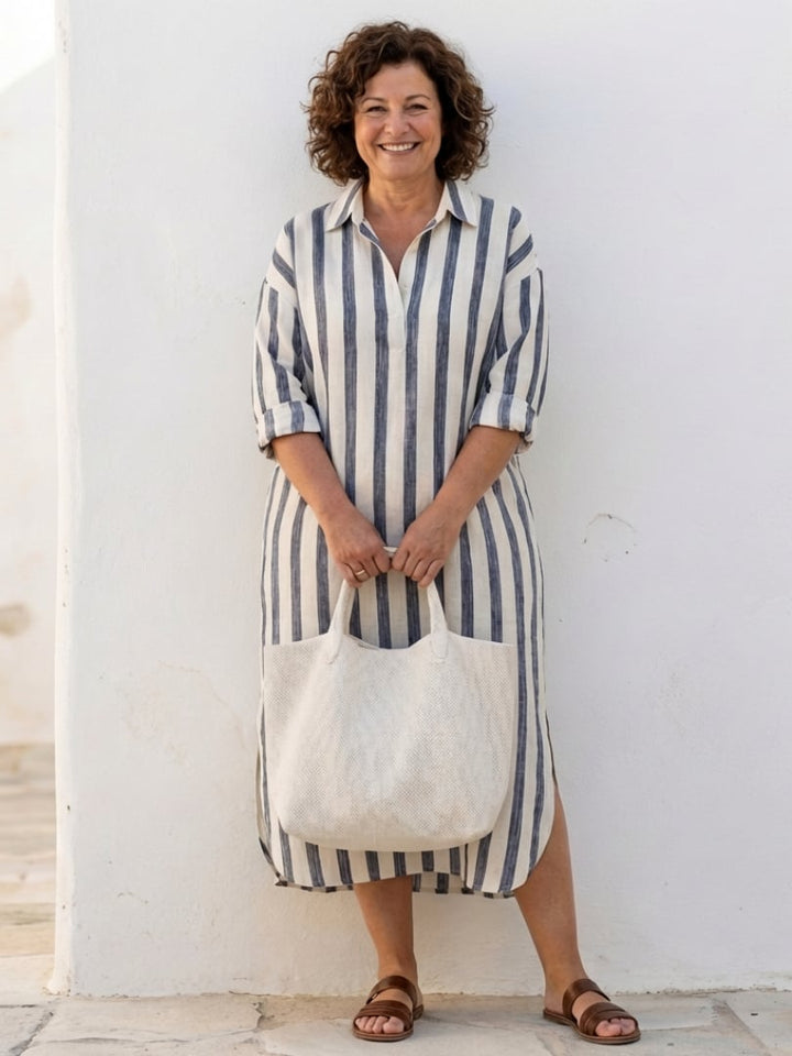Back view of the Brielle striped long sleeve midi dress in blue showing relaxed silhouette