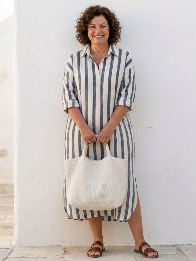 Back view of the Brielle striped long sleeve midi dress in blue showing relaxed silhouette