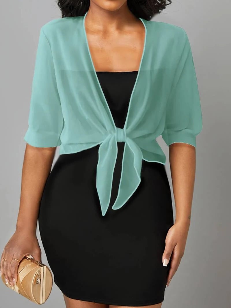 Front view of the Brisa open-front blouse in black layered over a black cami
