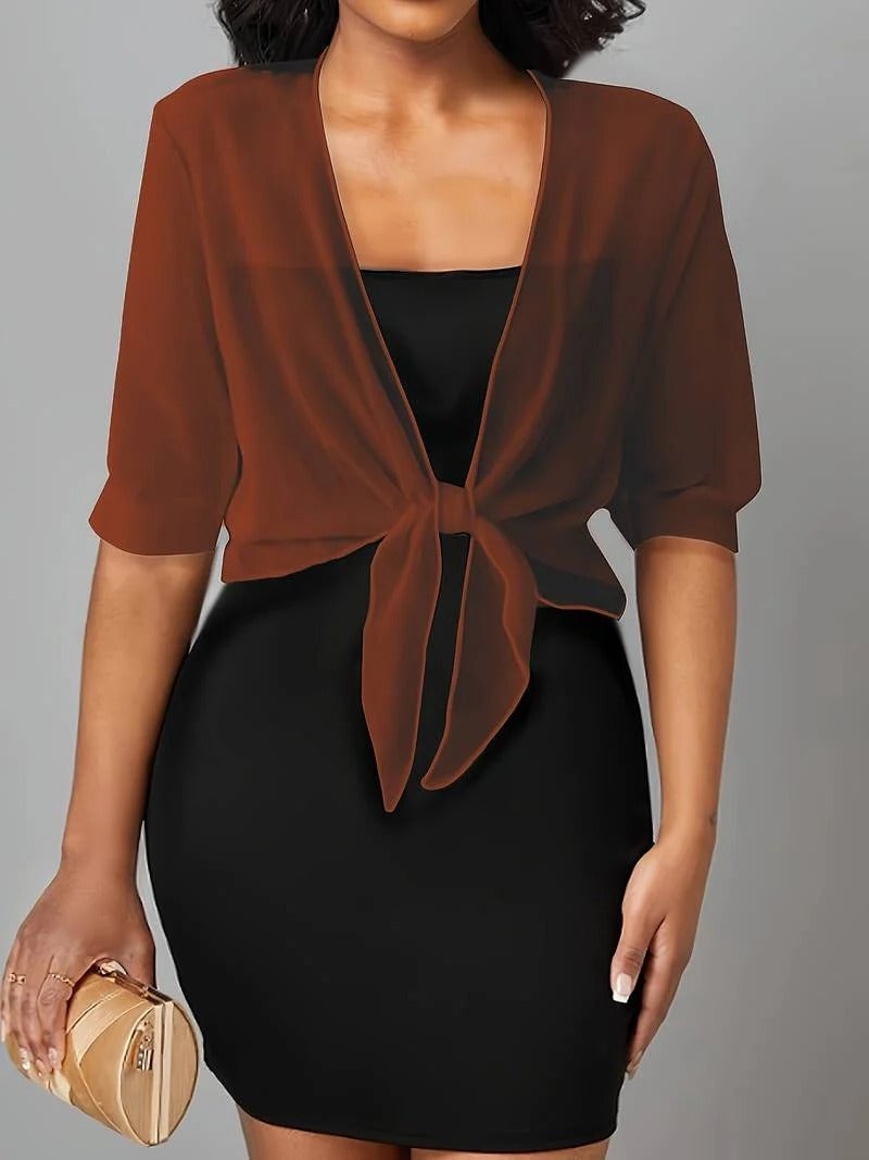 Side view of the Brisa sheer blouse in black showing the relaxed drape