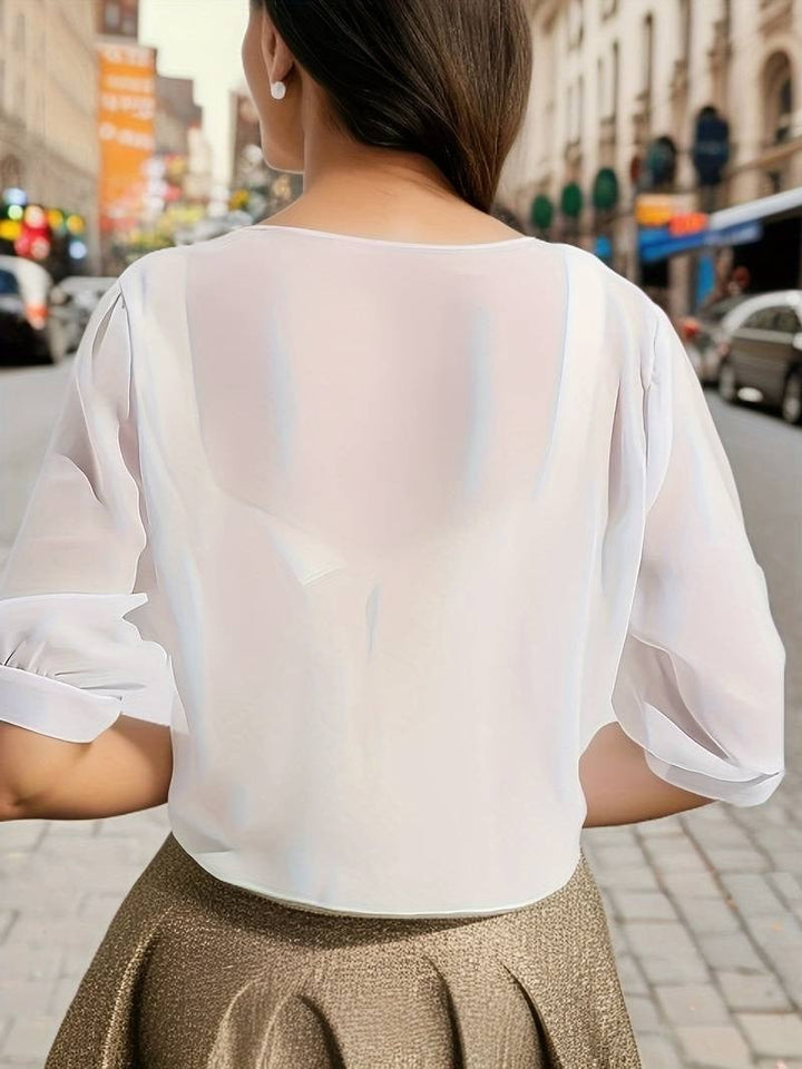 Front view of the Brisa open-front blouse in red styled over a neutral cami