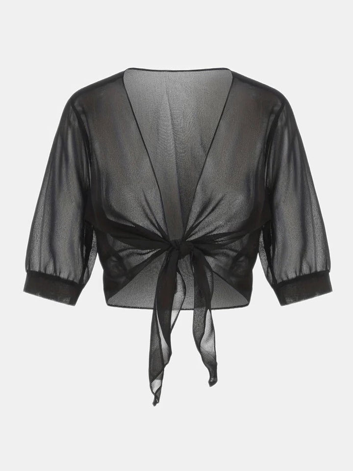 Close-up of the 3/4 roll-tab sleeve on the Brisa blouse in purple