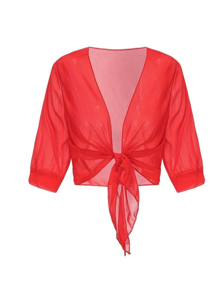 Close-up of the tie knot hem on the Brisa sheer blouse in light blue