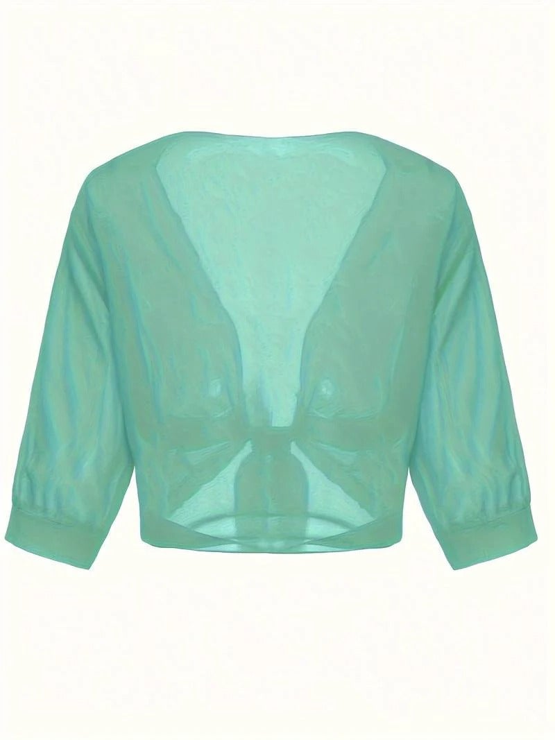 Close-up of the roll-tab sleeve detail on the Brisa blouse in emerald