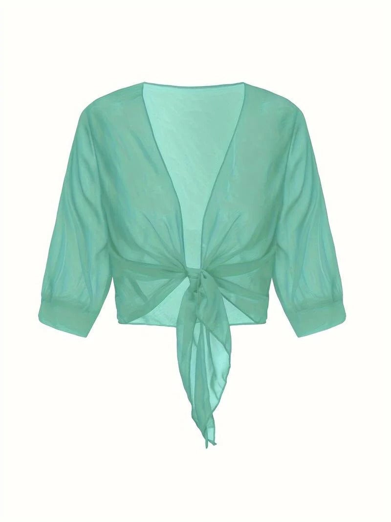 Side view of the Brisa sheer blouse in emerald showing the relaxed open-front fit