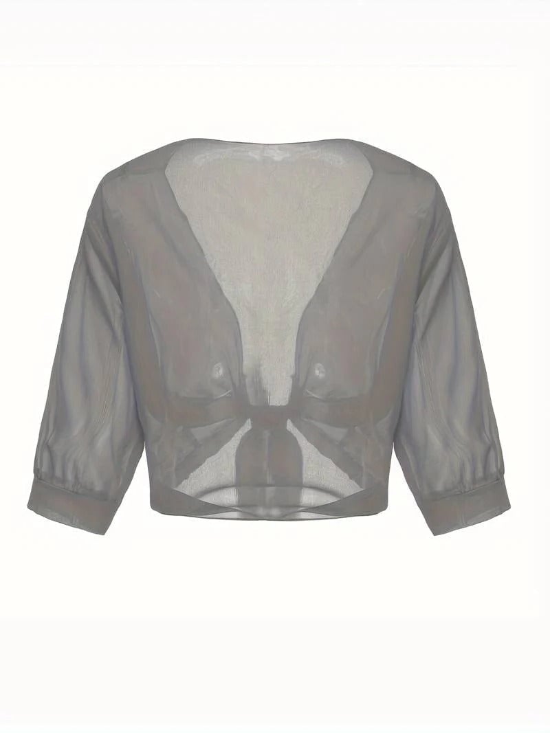 Woman wearing the Brisa sheer tie front blouse in light gray