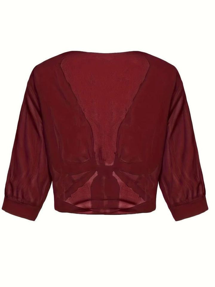 Close-up of the tie knot hem on the Brisa sheer blouse in caramel