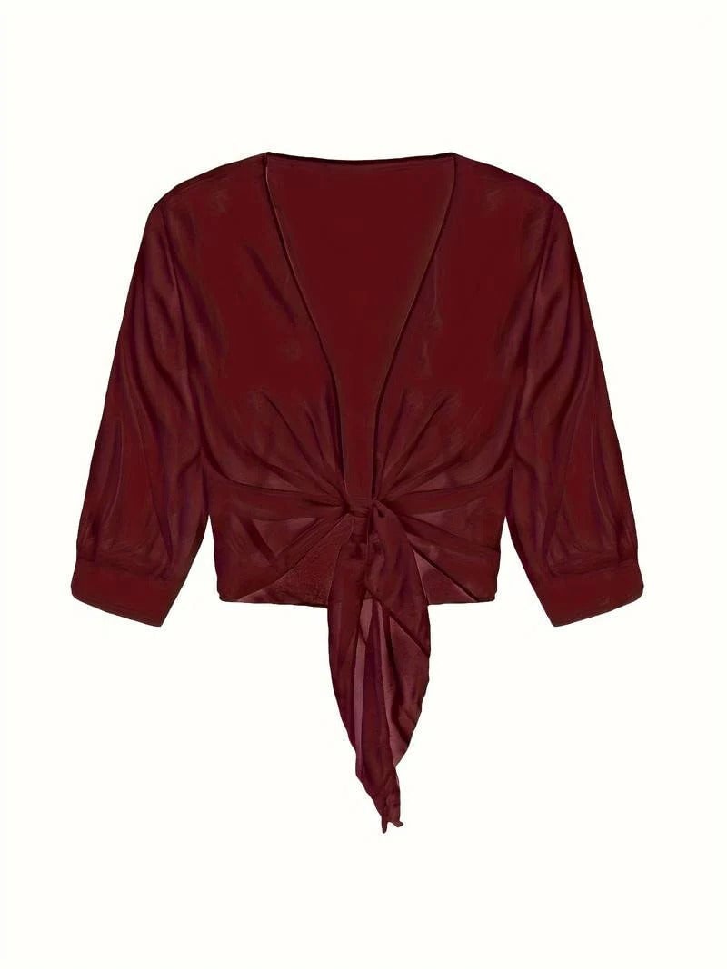 Flat lay of the Brisa sheer open-front blouse showing the full silhouette and tie hem detail