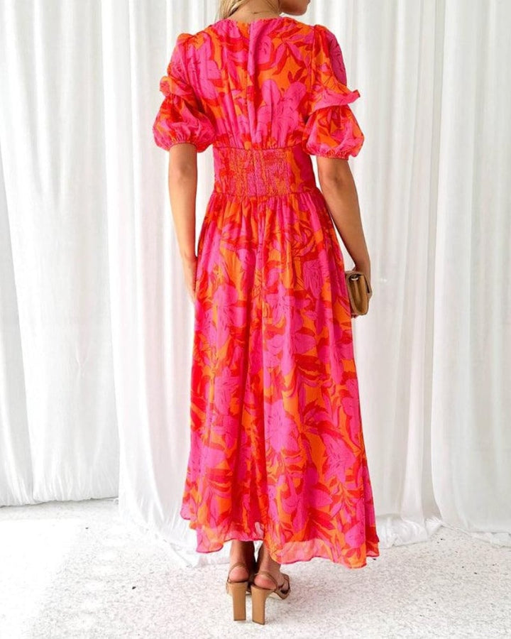 Full-length view of a model in a lightweight red-pink maxi dress, showcasing the elongating silhouette