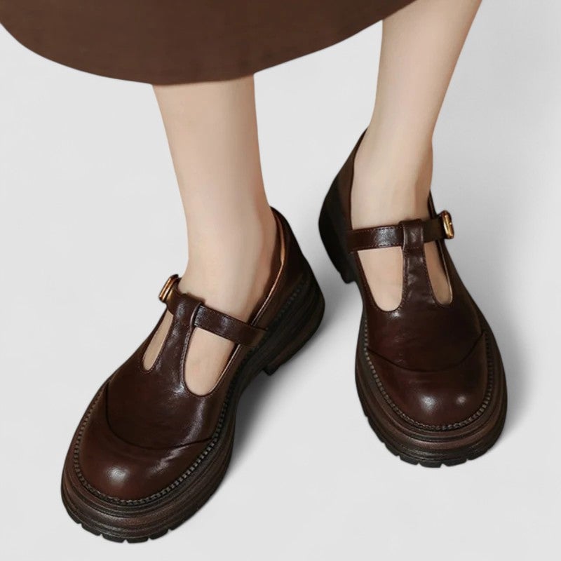 Front view of brown orthopedic mary jane shoes with adjustable strap on white background