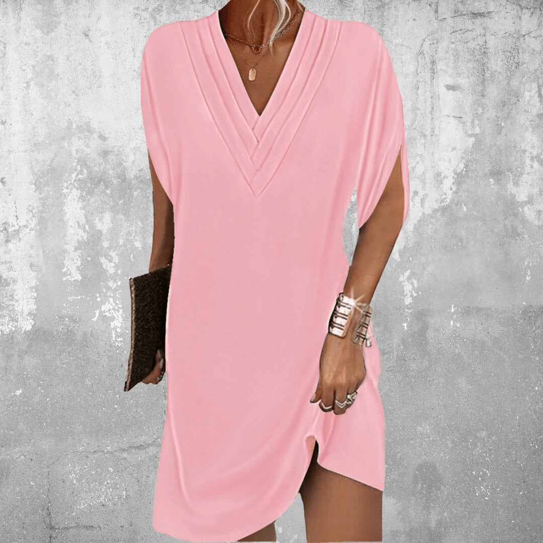 Close-up of the Brooke dress chic sleeve cut-out detail and flowing lightweight fabric