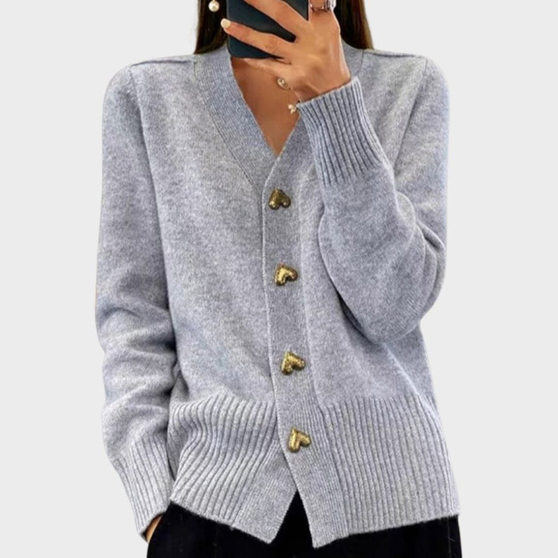 Woman wearing a soft gray heart button cardigan with a flattering relaxed silhouette