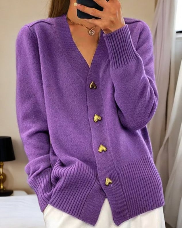 Front view of a woman styled in a white heart button cardigan over a casual outfit