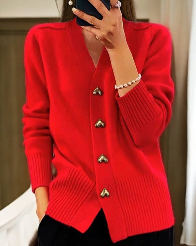 Woman in a purple heart button cardigan paired with jeans for an everyday look
