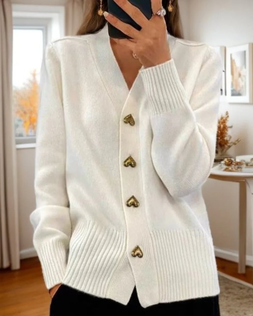 Woman wearing a black elegant heart button cardigan with a polished, layered look