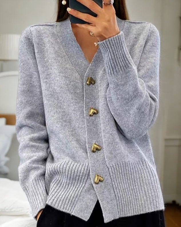 Flat lay of the heart button cardigan showing full length and button detail