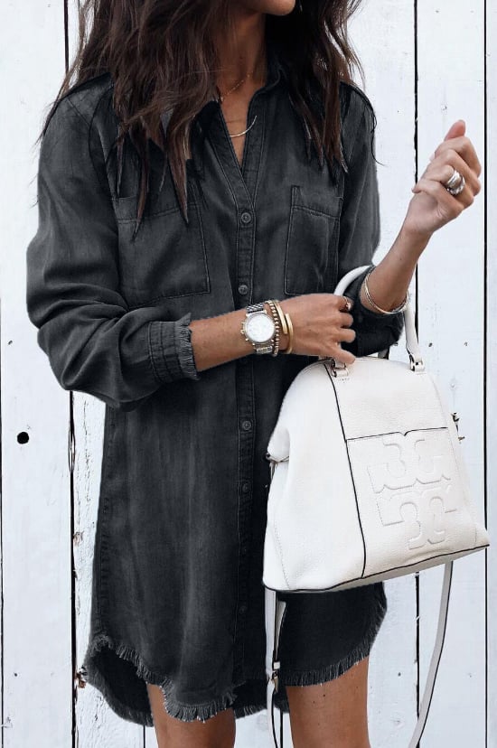Close-up of the Brooke shirt dress buttoned cuffs and raw frayed hem in a washed denim fabric