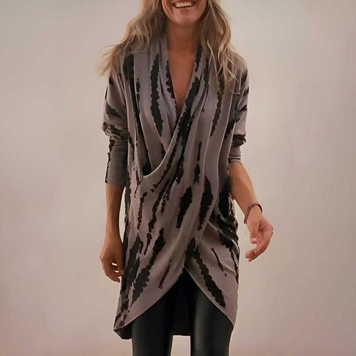 Woman wearing a soft gray V-neck tunic with a relaxed, flattering fit
