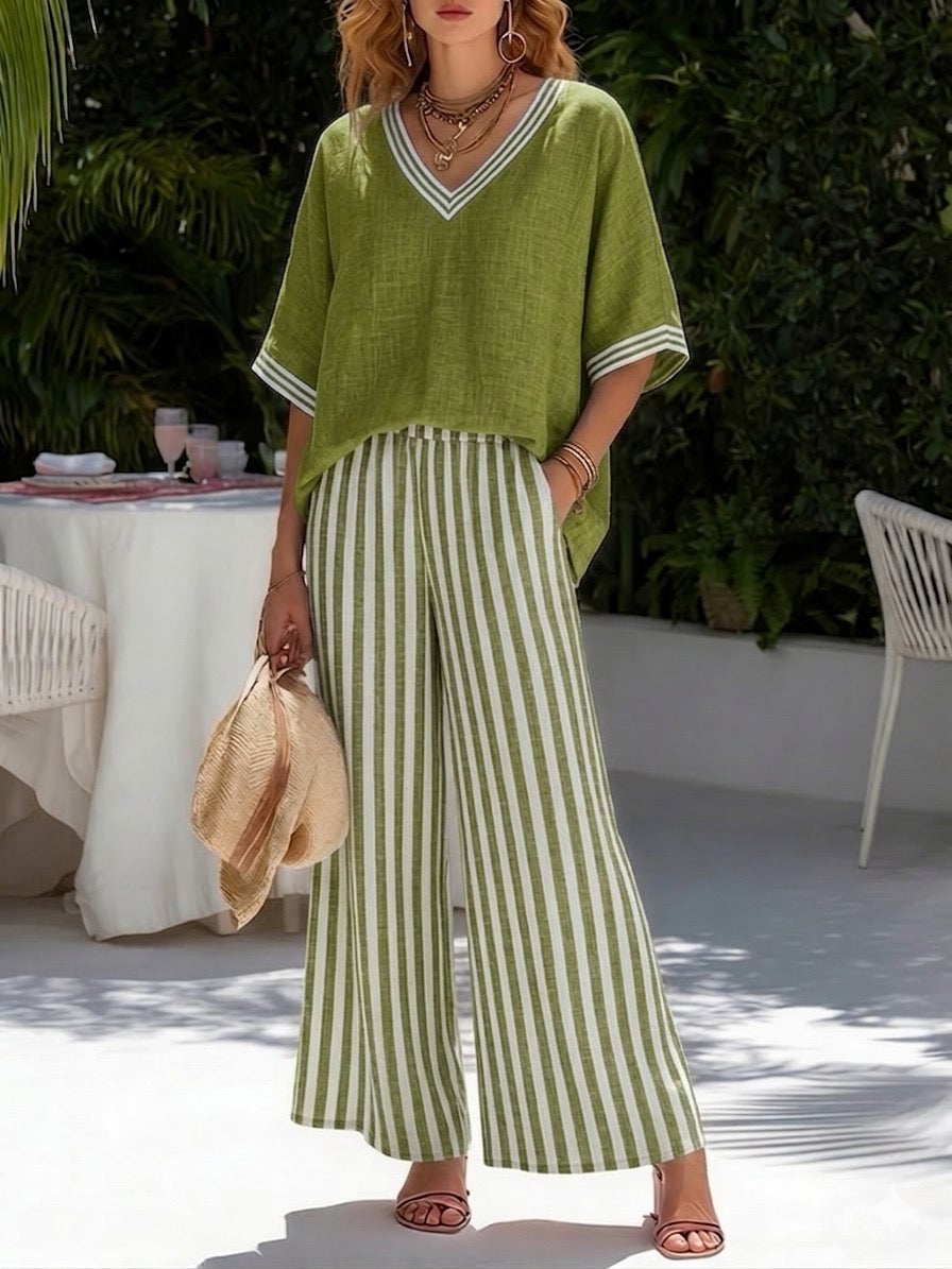 Woman styled in the Brynn striped pants set with sandals and a tote bag