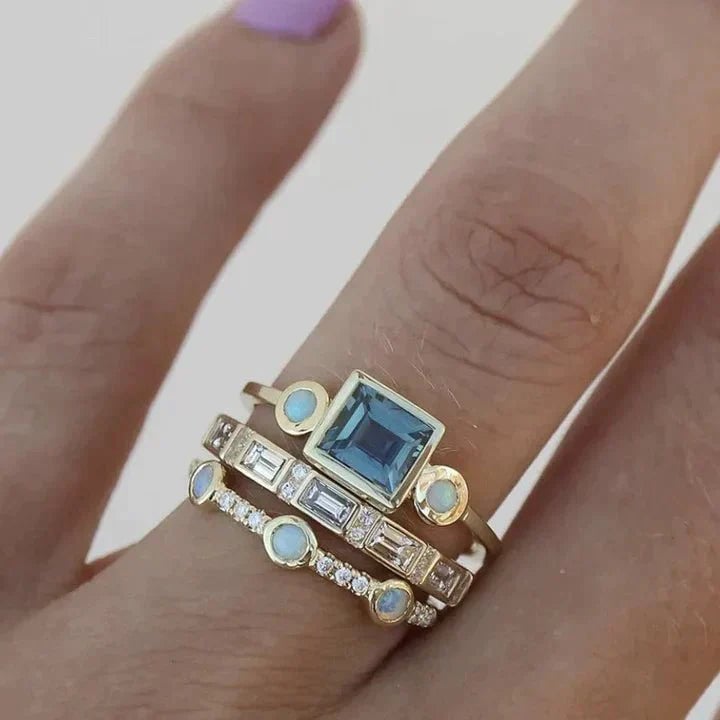 Close-up of a vintage-inspired blue crystal ring with an elegant faceted stone centerpiece