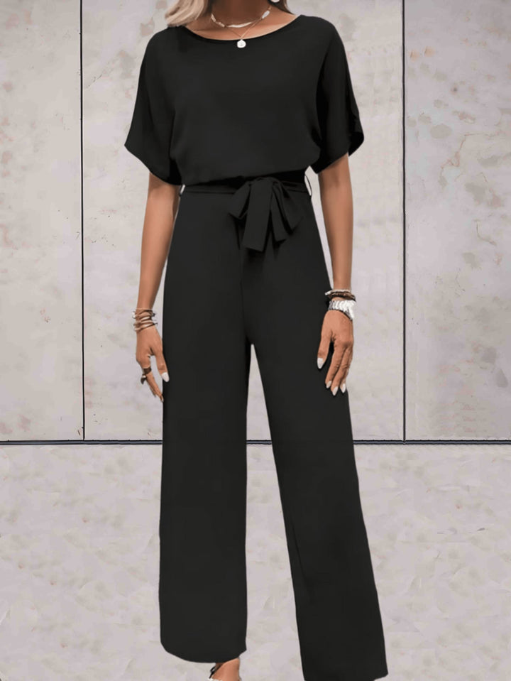 Woman styling the Cali two-piece set in black with flat sandals for a casual daytime look