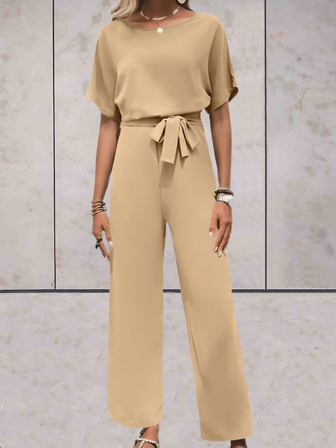 Woman wearing the Cali two-piece set in green styled with heeled mules for a polished occasion look
